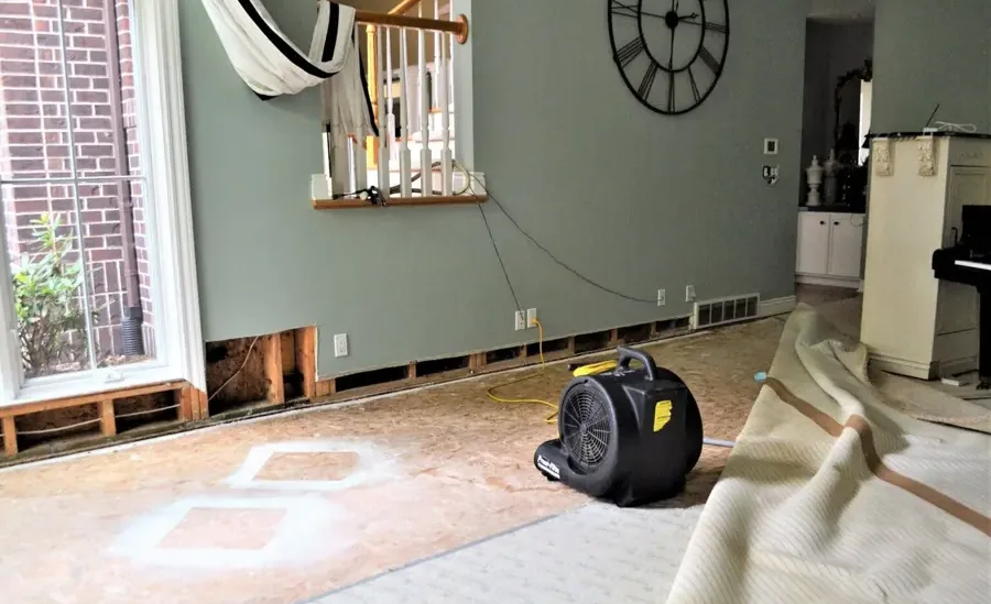 Restoration crew drying out a water damaged home
